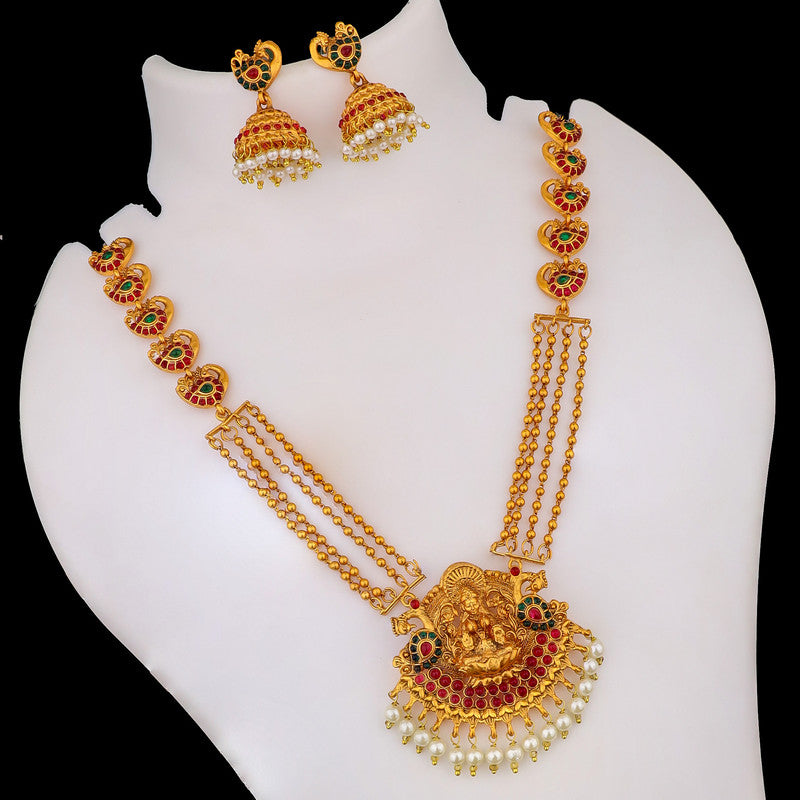 A gold necklace set with intricate designs, featuring a central deity pendant, red and green accents, and matching earrings with pearl details.