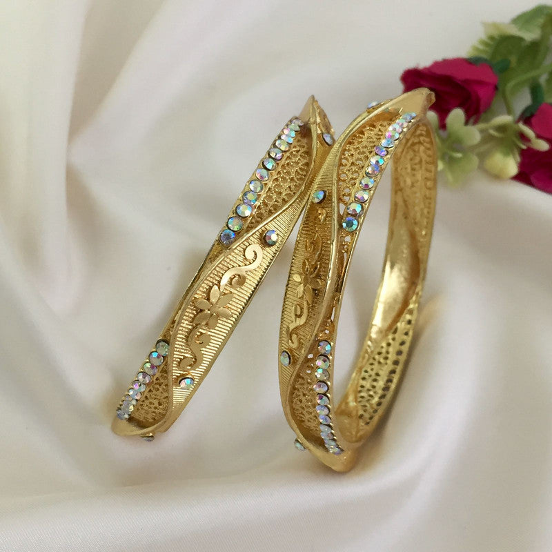 Two intricately designed gold bangles adorned with small, sparkling gemstones.