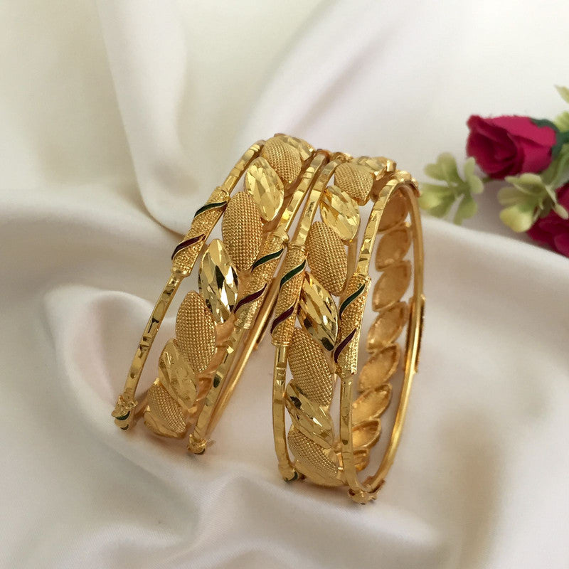 Two intricately designed gold bangles with leaf patterns.