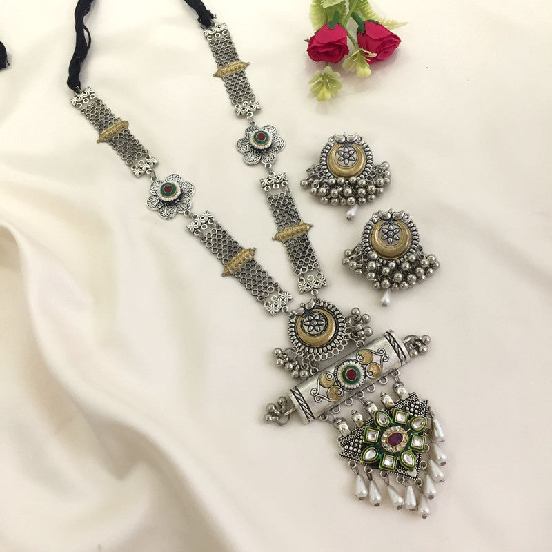 Silver oxidized jewelry set with a long necklace and matching earrings featuring intricate designs and colorful stones.