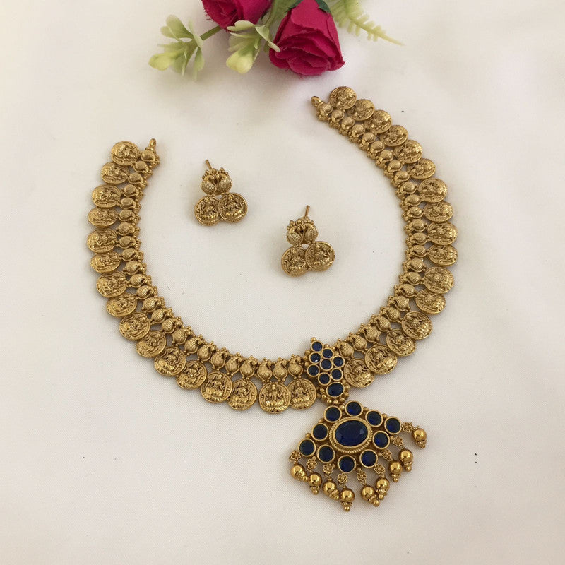 Gold coin necklace set with matching earrings and blue stone pendant.