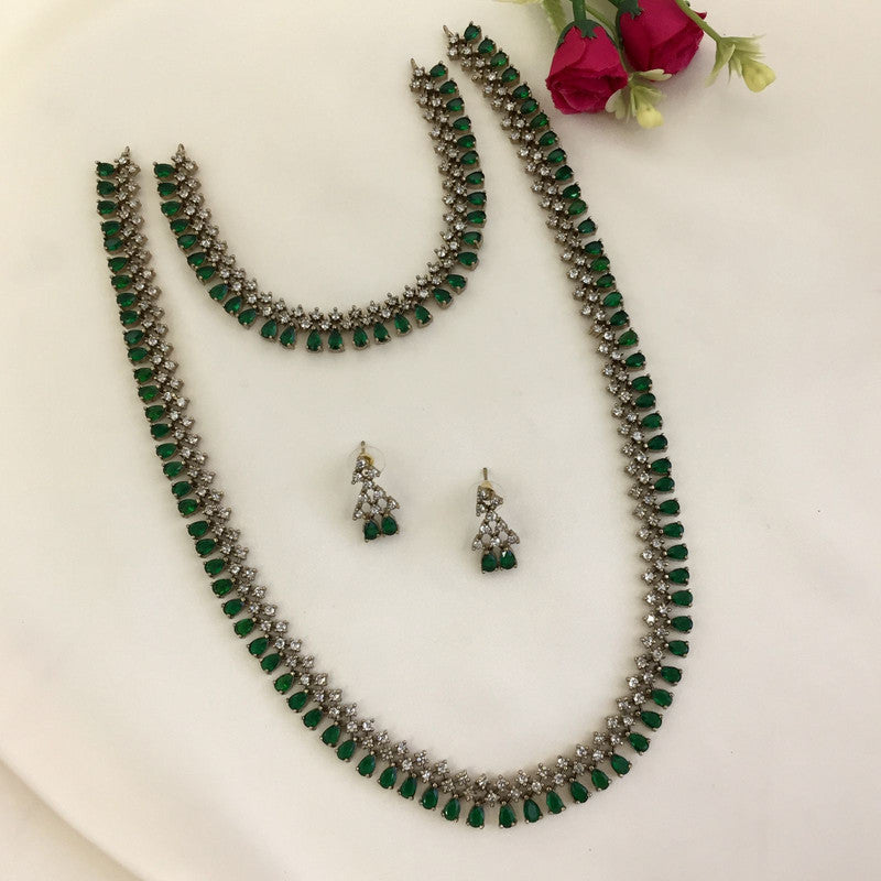 A jewelry set consisting of a necklace, a choker, and a pair of earrings with green and white stones.