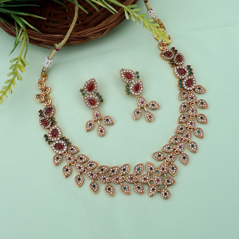 Elegant gold-plated necklace set featuring red and green stones, accompanied by matching earrings.