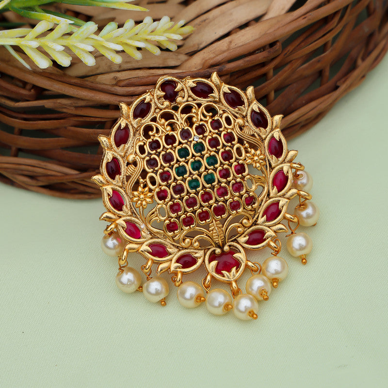 Elegant gold-plated brooch featuring intricate Jadai design adorned with ruby and emerald stones, complemented by a delicate pearl dangling.