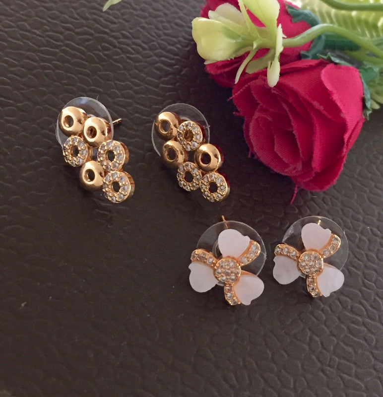 Three pairs of stud earrings with floral designs, featuring gold and rhinestone accents.