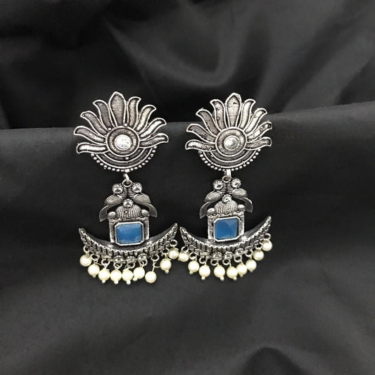 Silver oxidized earrings with floral design, blue stone, and pearl danglers.