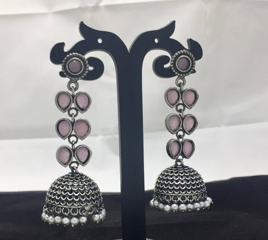 Blushing pink soft pink hanging jhumki earrings with intricate silver detailing and pearl accents.